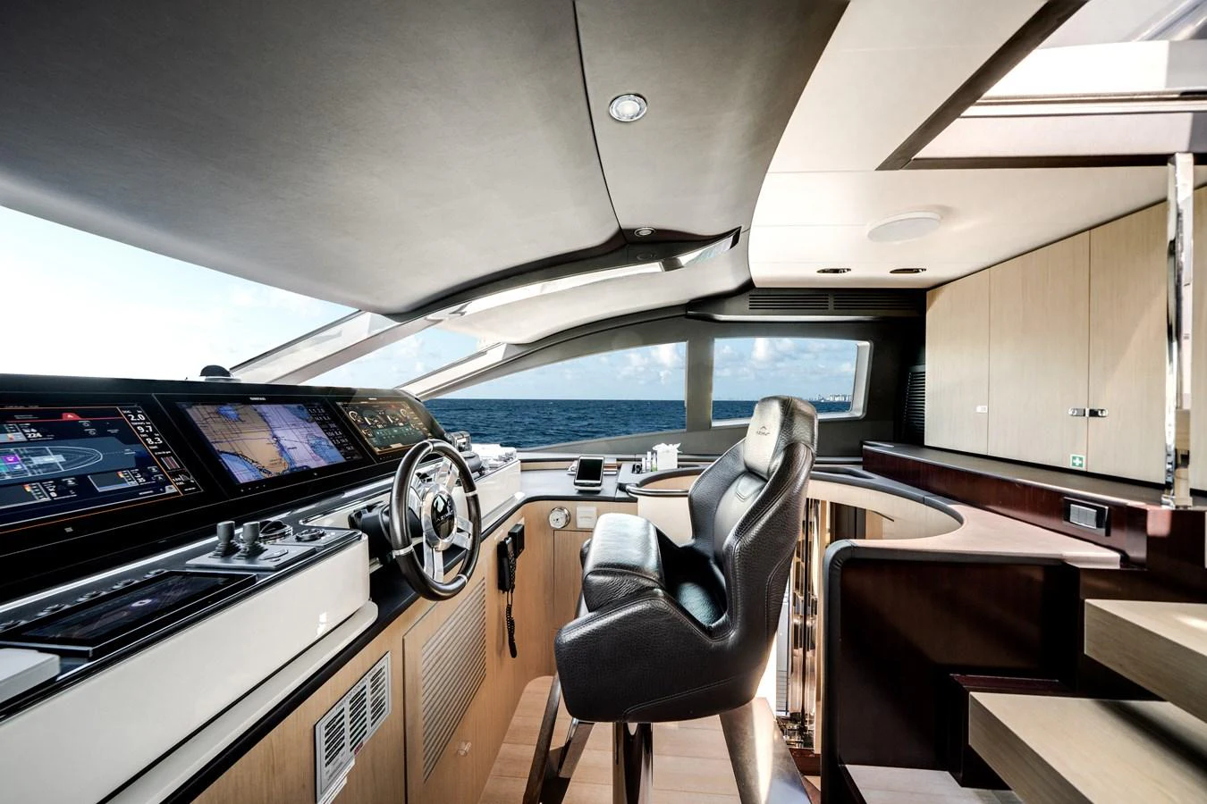 The helm station features state-of-the-art navigation equipment and luxurious seating with a panoramic ocean view. aboard PIER PRESSURE Yacht for Sale