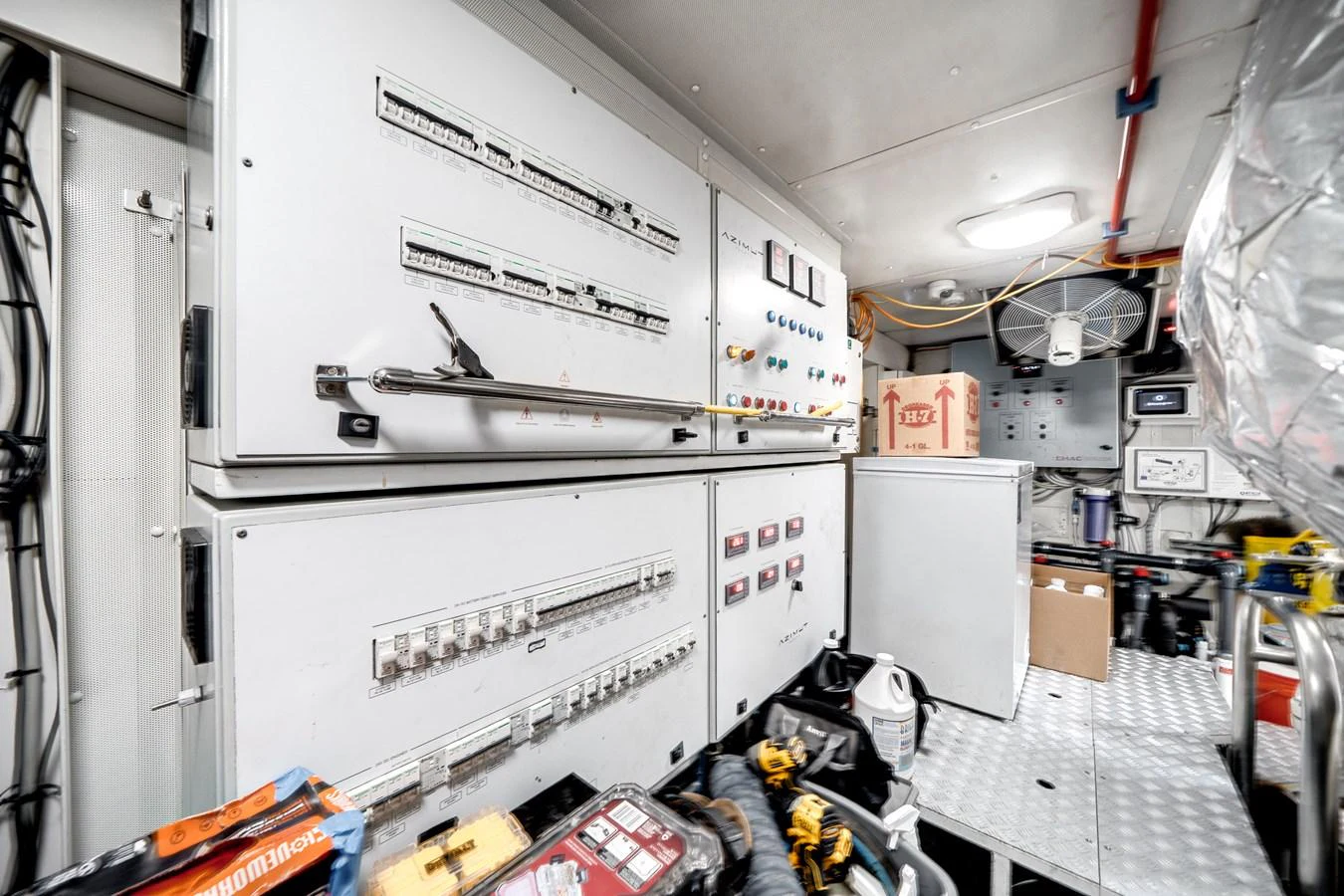 The image shows the engine room with various control panels and equipment. aboard PIER PRESSURE Yacht for Sale