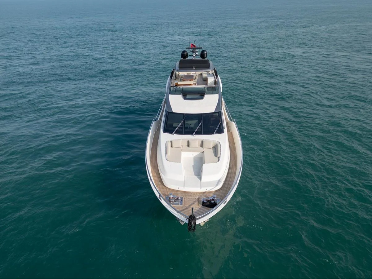 A sleek yacht cruises on calm waters, showcasing its elegant design and spacious deck. aboard TNT LEISURE Yacht for Sale