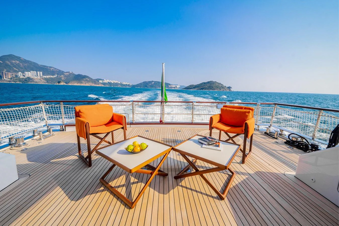 The aft deck offers a stunning view of the open sea, with comfortable seating and stylish tables. aboard TNT LEISURE Yacht for Sale