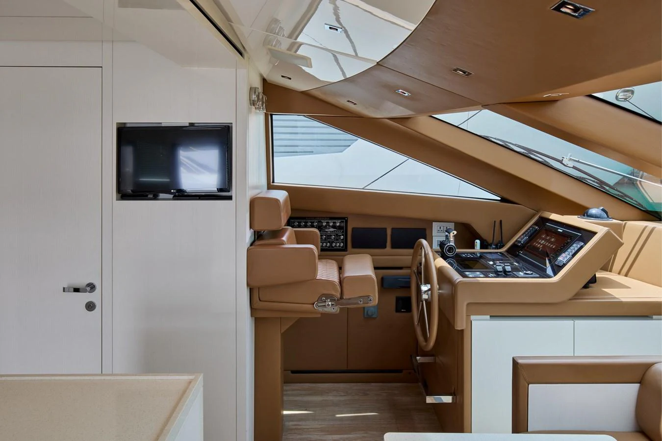 The helm station features a sleek design with advanced navigation equipment and comfortable seating. aboard TNT LEISURE Yacht for Sale