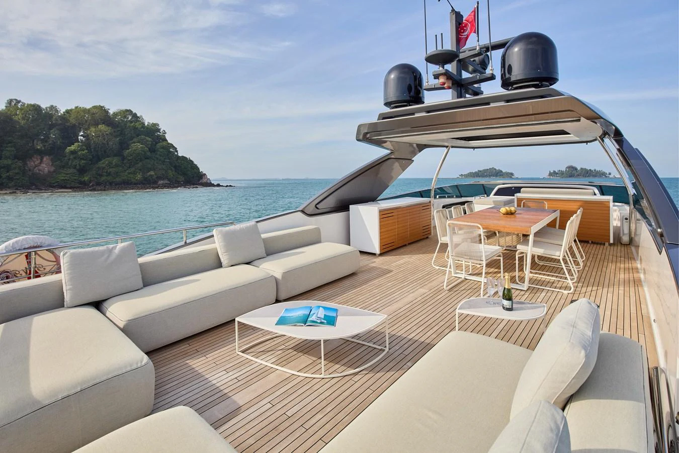 The sundeck offers a spacious and luxurious lounging area with comfortable seating and a dining table, perfect for relaxation and socializing. aboard TNT LEISURE Yacht for Sale