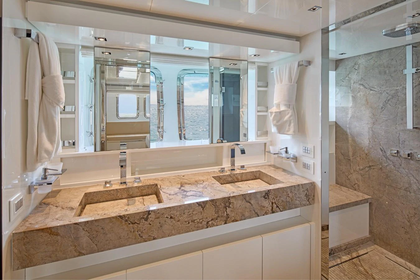 The yacht's bathroom features a luxurious double sink vanity with marble countertops and a spacious shower area. aboard TNT LEISURE Yacht for Sale