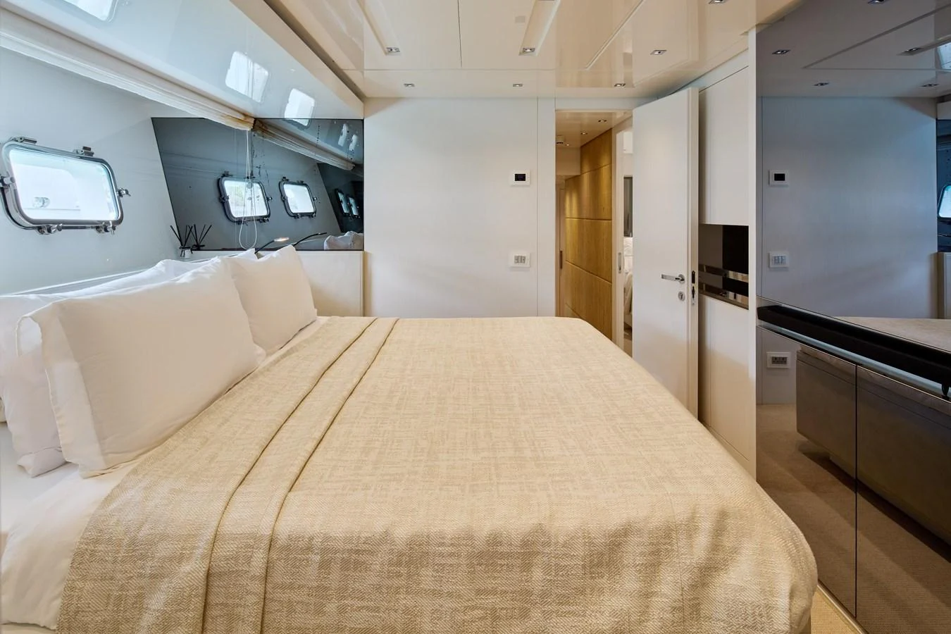 The master stateroom features a luxurious bed with ample natural light from the windows. aboard TNT LEISURE Yacht for Sale