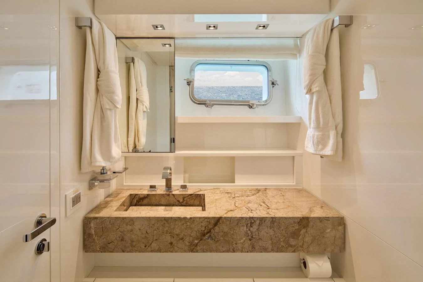 A luxurious yacht bathroom featuring a marble countertop and a scenic window view. aboard TNT LEISURE Yacht for Sale