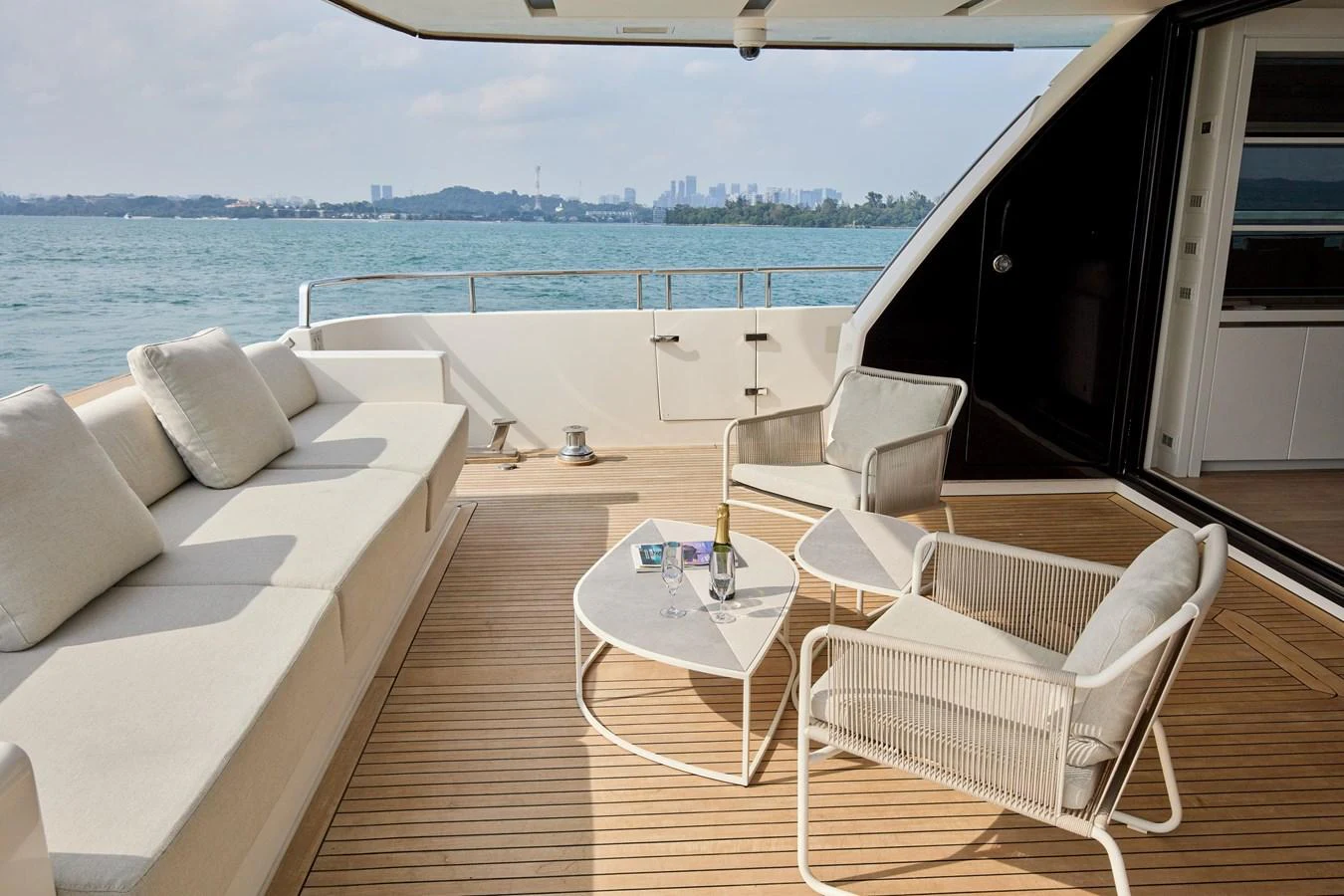 The aft deck features a comfortable seating area with a scenic view of the water. aboard TNT LEISURE Yacht for Sale