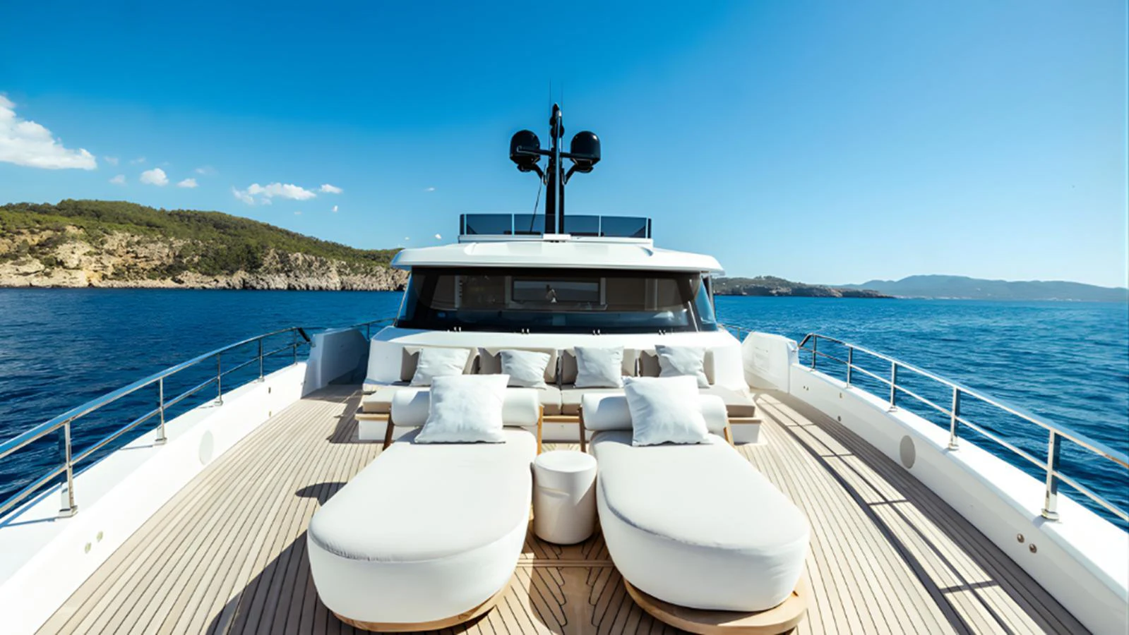 The foredeck of this yacht offers luxurious sun loungers and a spacious seating area with stunning ocean views. aboard MARCH SUNRISE Yacht for Sale
