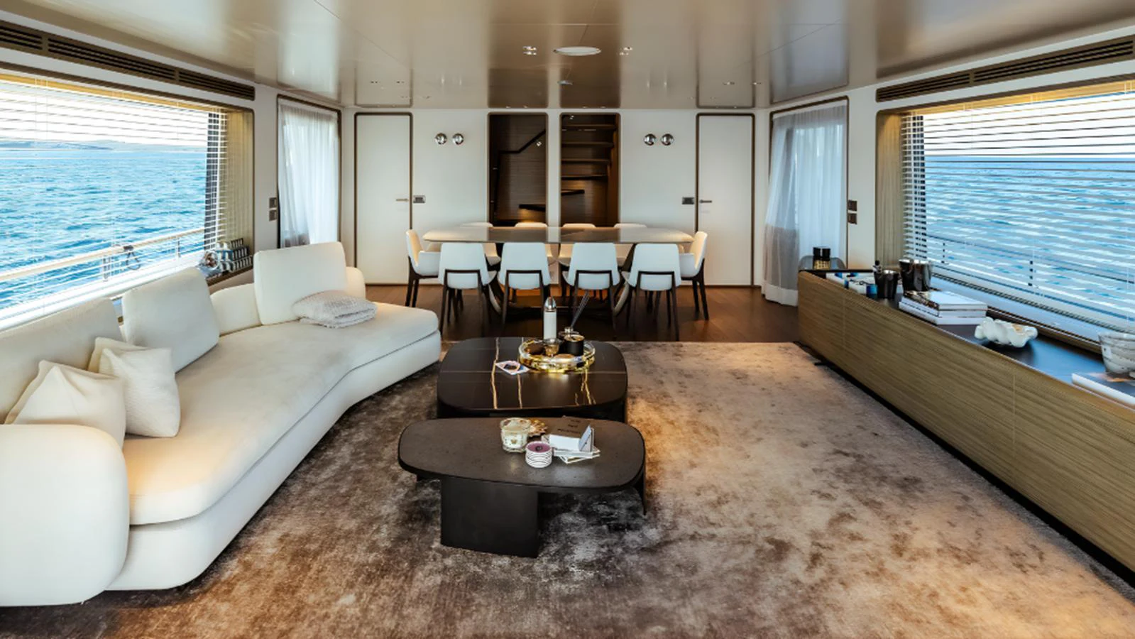 The spacious salon features elegant furnishings and panoramic windows offering stunning ocean views. aboard MARCH SUNRISE Yacht for Sale