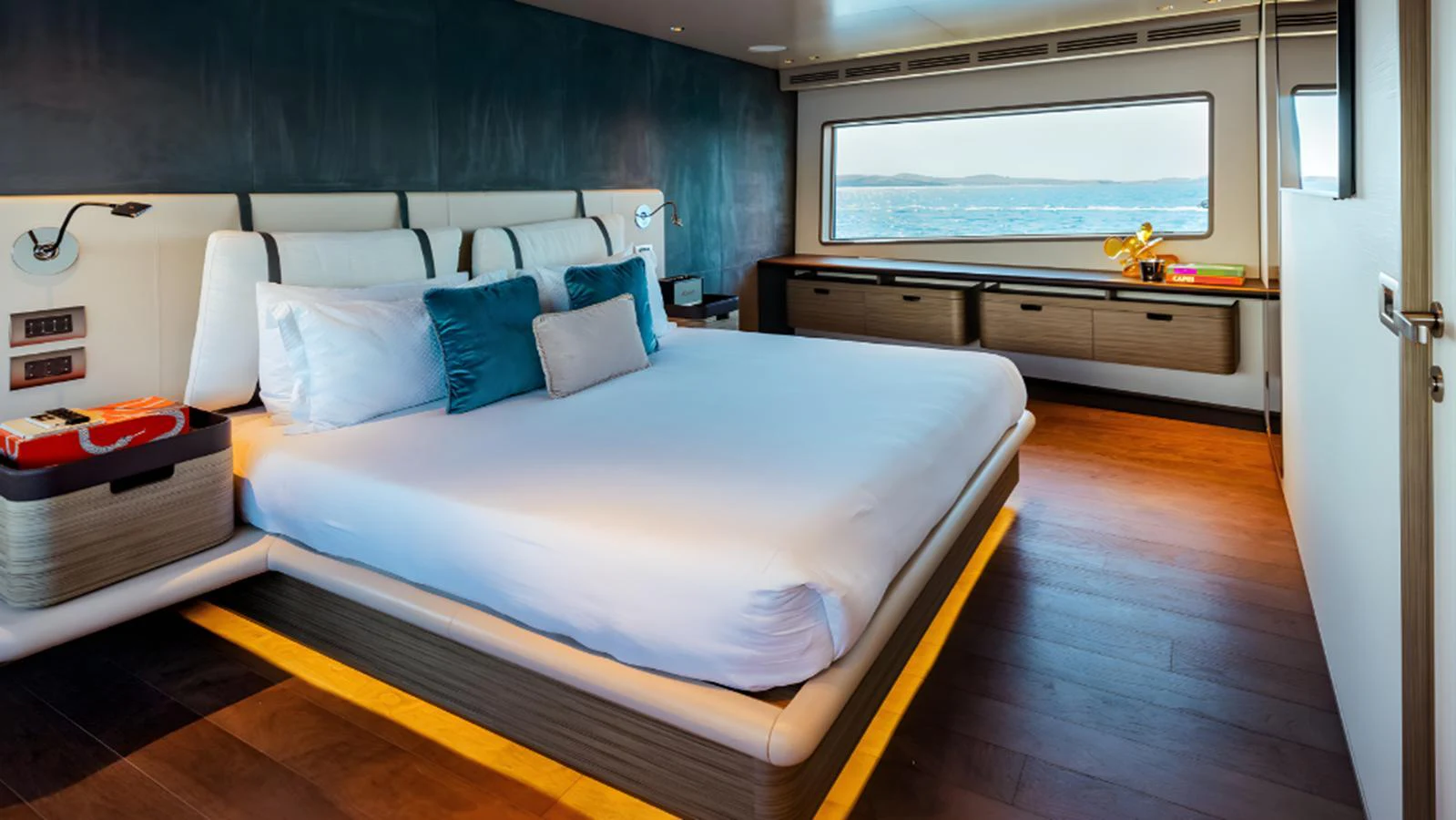 The master stateroom features a spacious bed, modern decor, and a large window with a stunning sea view. aboard MARCH SUNRISE Yacht for Sale