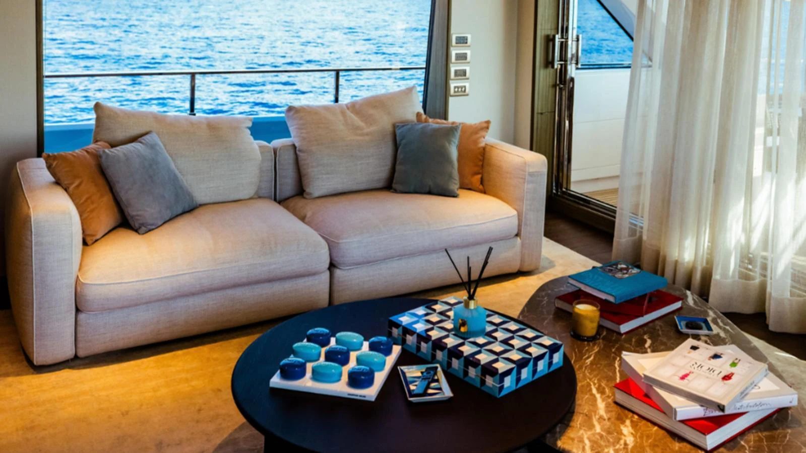 The salon features a comfortable seating area with a stunning view of the ocean through large windows. aboard MARCH SUNRISE Yacht for Sale