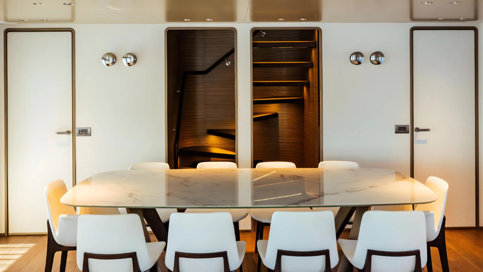 The yacht's dining area features a sleek, modern design with a marble table and stylish white chairs. aboard MARCH SUNRISE Yacht for Sale