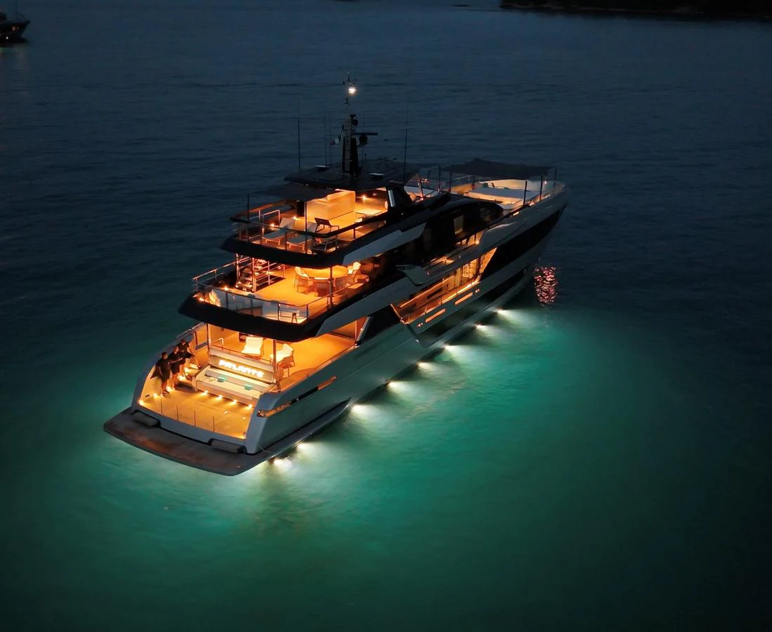 A stunning yacht illuminated at night, showcasing its elegant design and ambient lighting. aboard ´LANTE Yacht for Sale