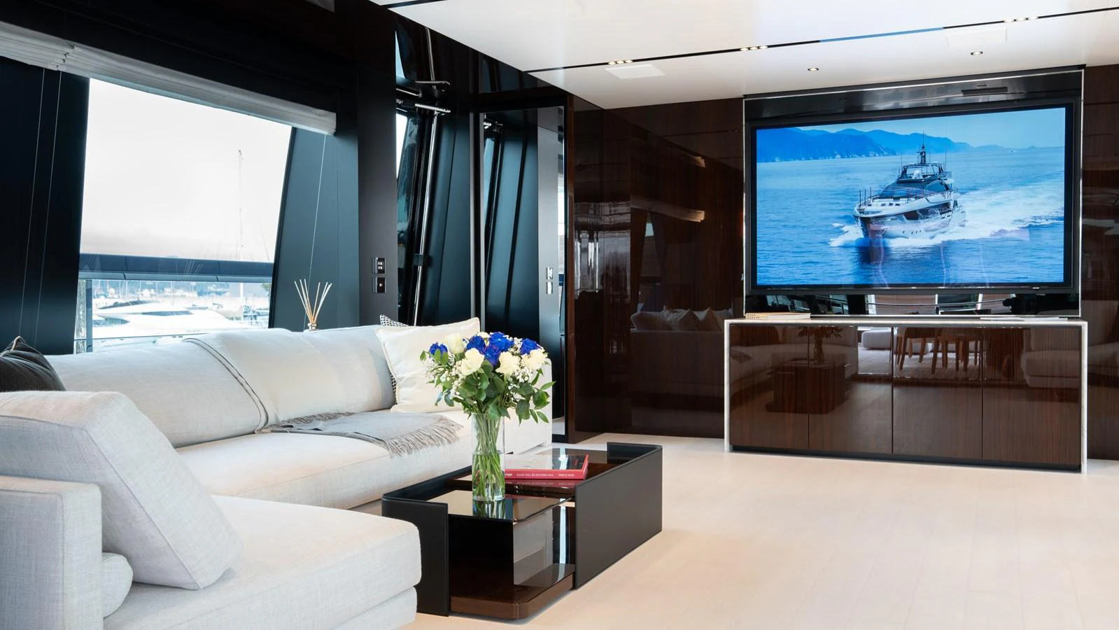 The salon features a spacious seating area with a large TV and elegant decor. aboard ´LANTE Yacht for Sale