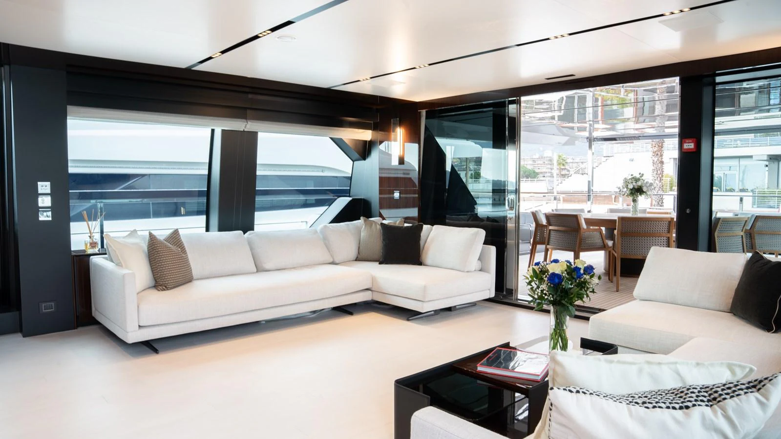 The salon features modern, luxurious furnishings with ample natural light and a seamless connection to the outdoor deck. aboard ´LANTE Yacht for Sale