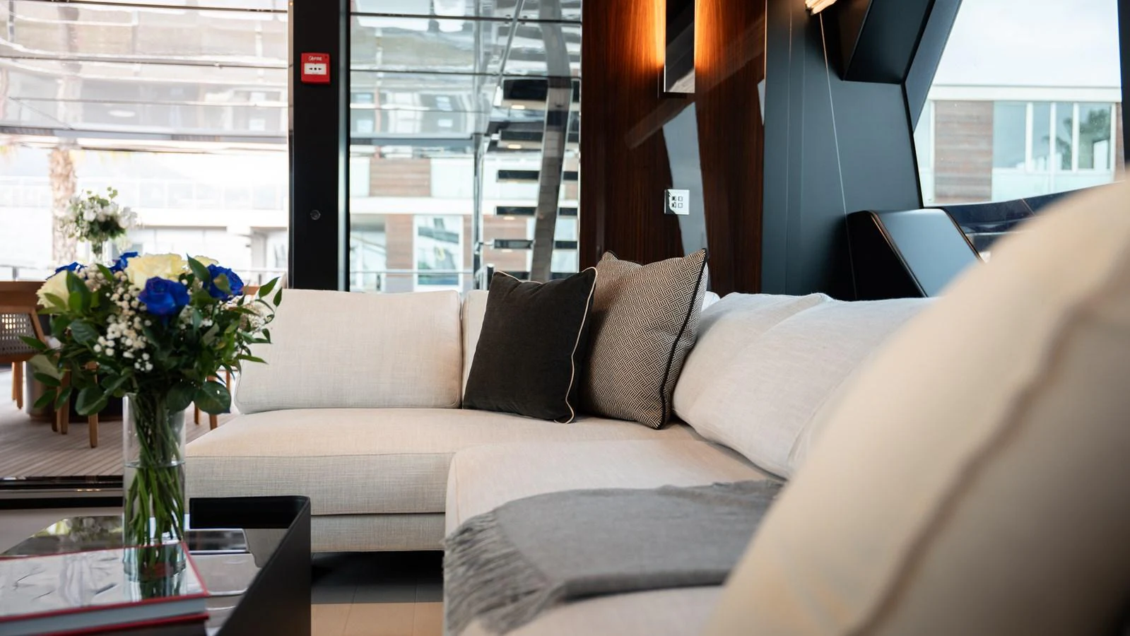 The salon features a comfortable and stylish seating area with modern decor and a bouquet of fresh flowers. aboard ´LANTE Yacht for Sale