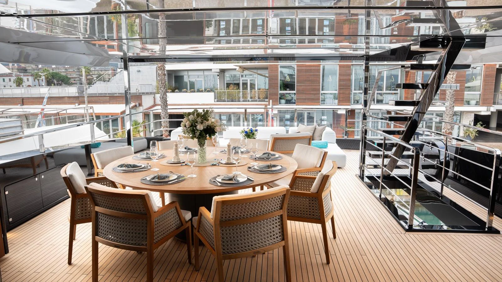 The aft deck features an elegant dining area with a round table and comfortable chairs, perfect for alfresco meals. aboard ´LANTE Yacht for Sale