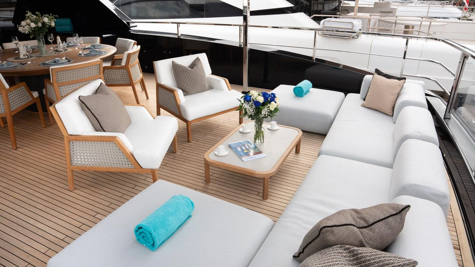 The aft deck features a luxurious seating area with plush cushions and a dining table, perfect for relaxation and socializing. aboard ´LANTE Yacht for Sale