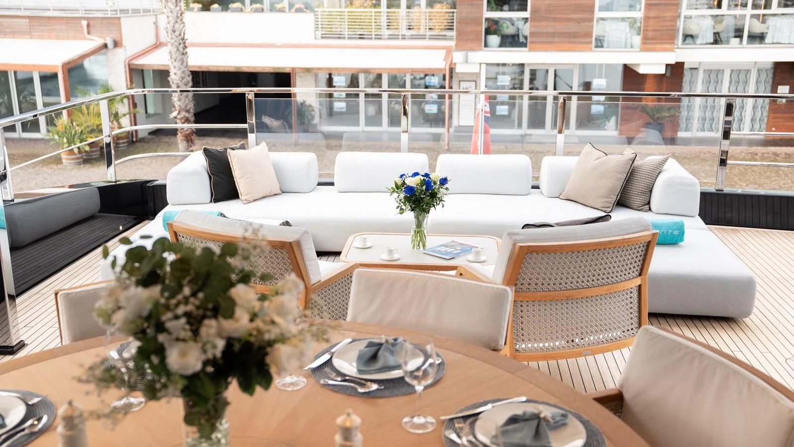 The aft deck features a stylish and comfortable seating area with a dining table set for an elegant meal. aboard ´LANTE Yacht for Sale