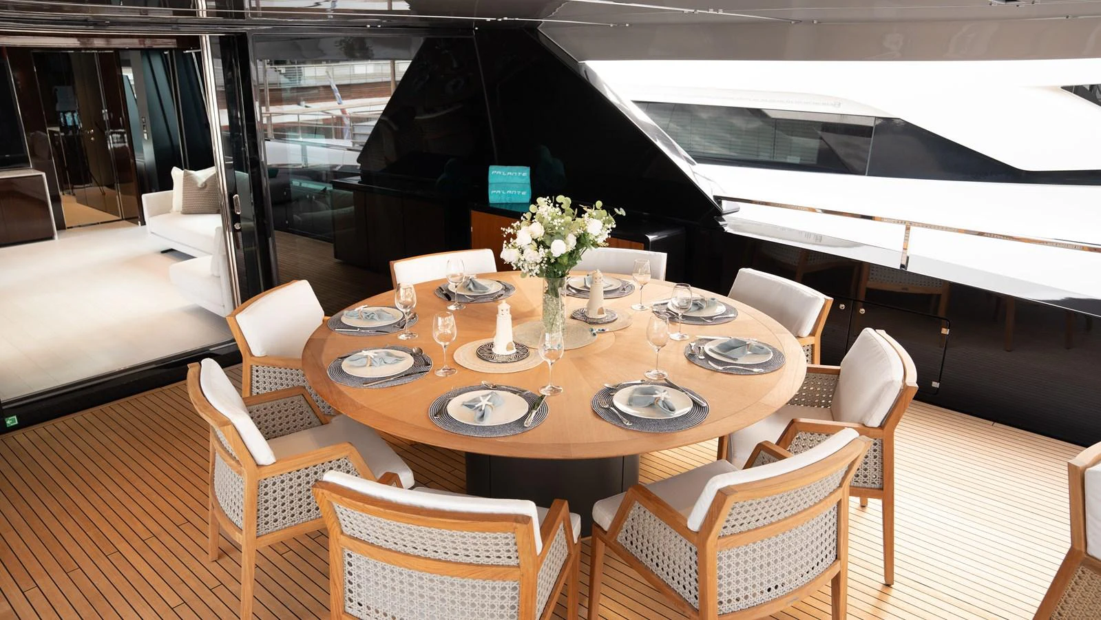 The aft deck features an elegant dining area with a round table and comfortable seating, perfect for alfresco meals. aboard ´LANTE Yacht for Sale