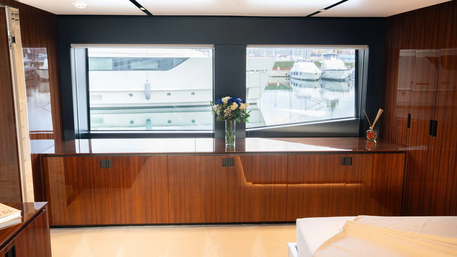 The yacht's interior features a sleek, modern design with large windows offering a view of the marina. aboard ´LANTE Yacht for Sale