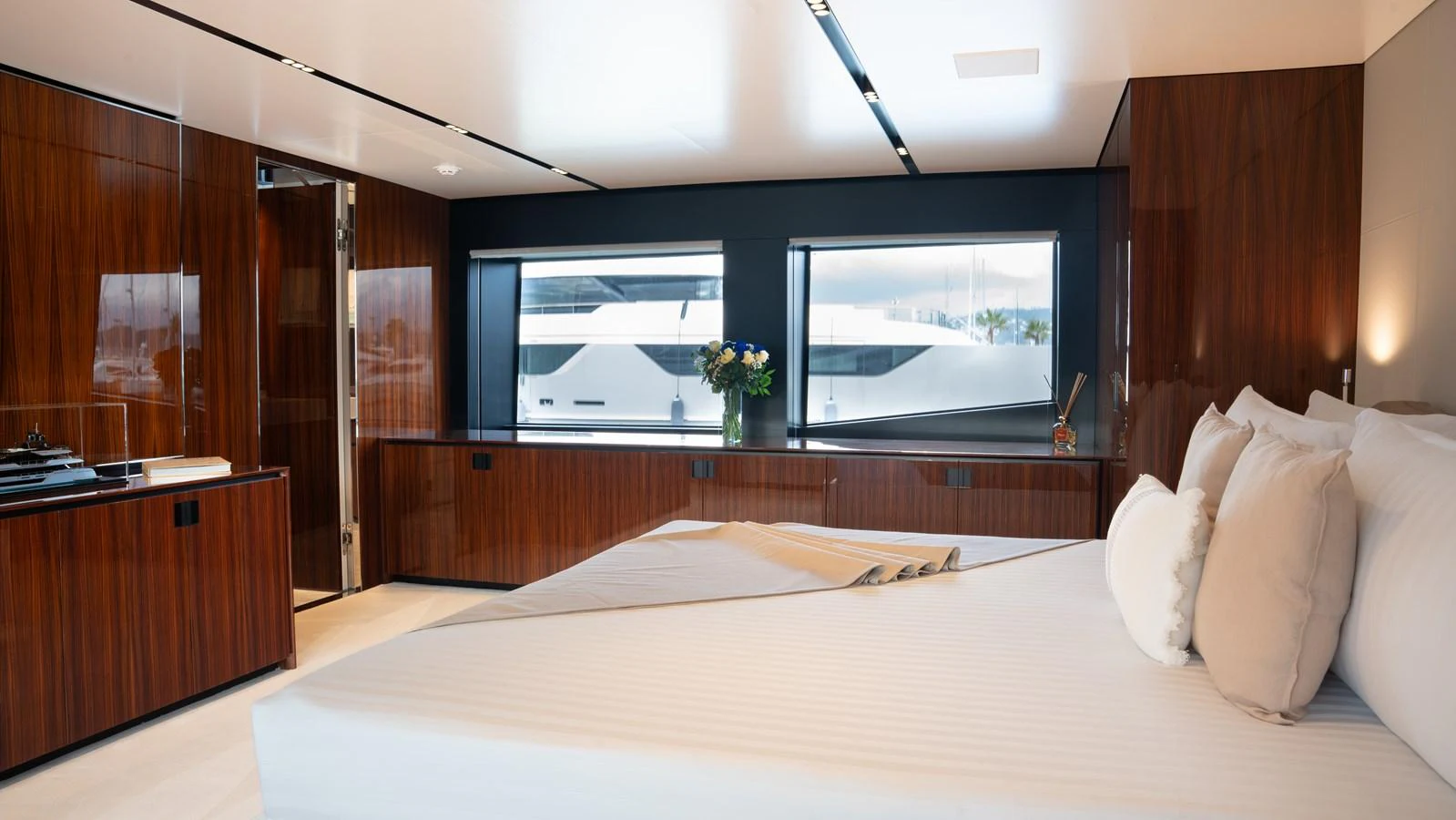 The master stateroom features luxurious wood paneling and large windows for natural light. aboard ´LANTE Yacht for Sale