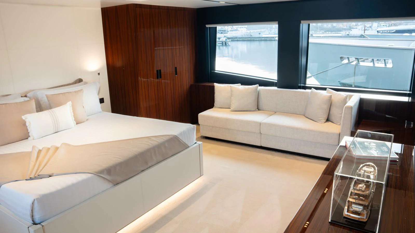 The master stateroom features a luxurious bed, a comfortable sofa, and large windows offering stunning views. aboard ´LANTE Yacht for Sale
