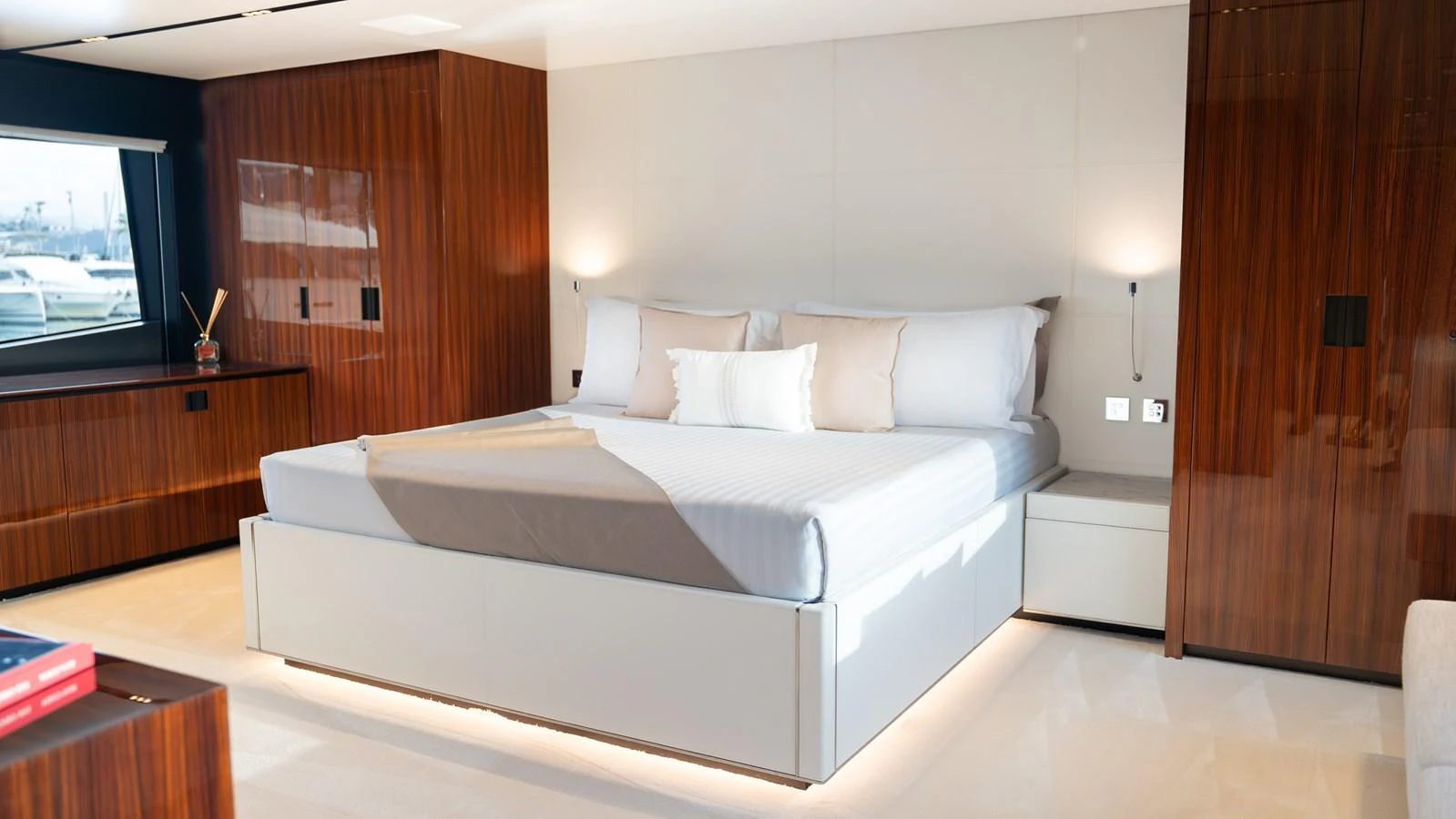 The master stateroom features a luxurious bed with elegant wood paneling and modern lighting. aboard ´LANTE Yacht for Sale