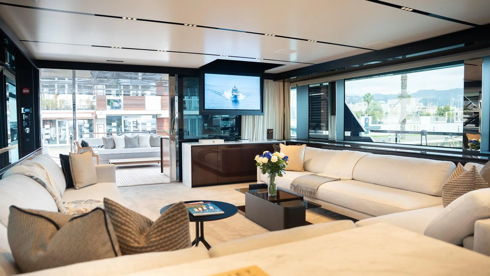 The spacious salon features luxurious seating and modern entertainment amenities with large windows offering stunning views. aboard ´LANTE Yacht for Sale