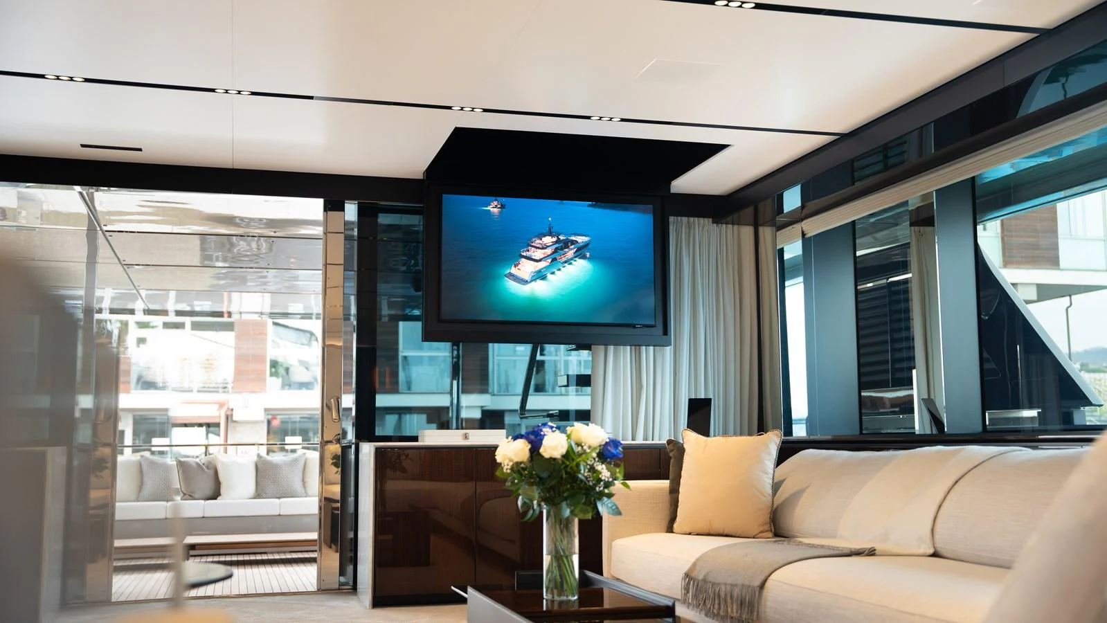 The salon features a comfortable seating area with a large TV and elegant decor. aboard ´LANTE Yacht for Sale