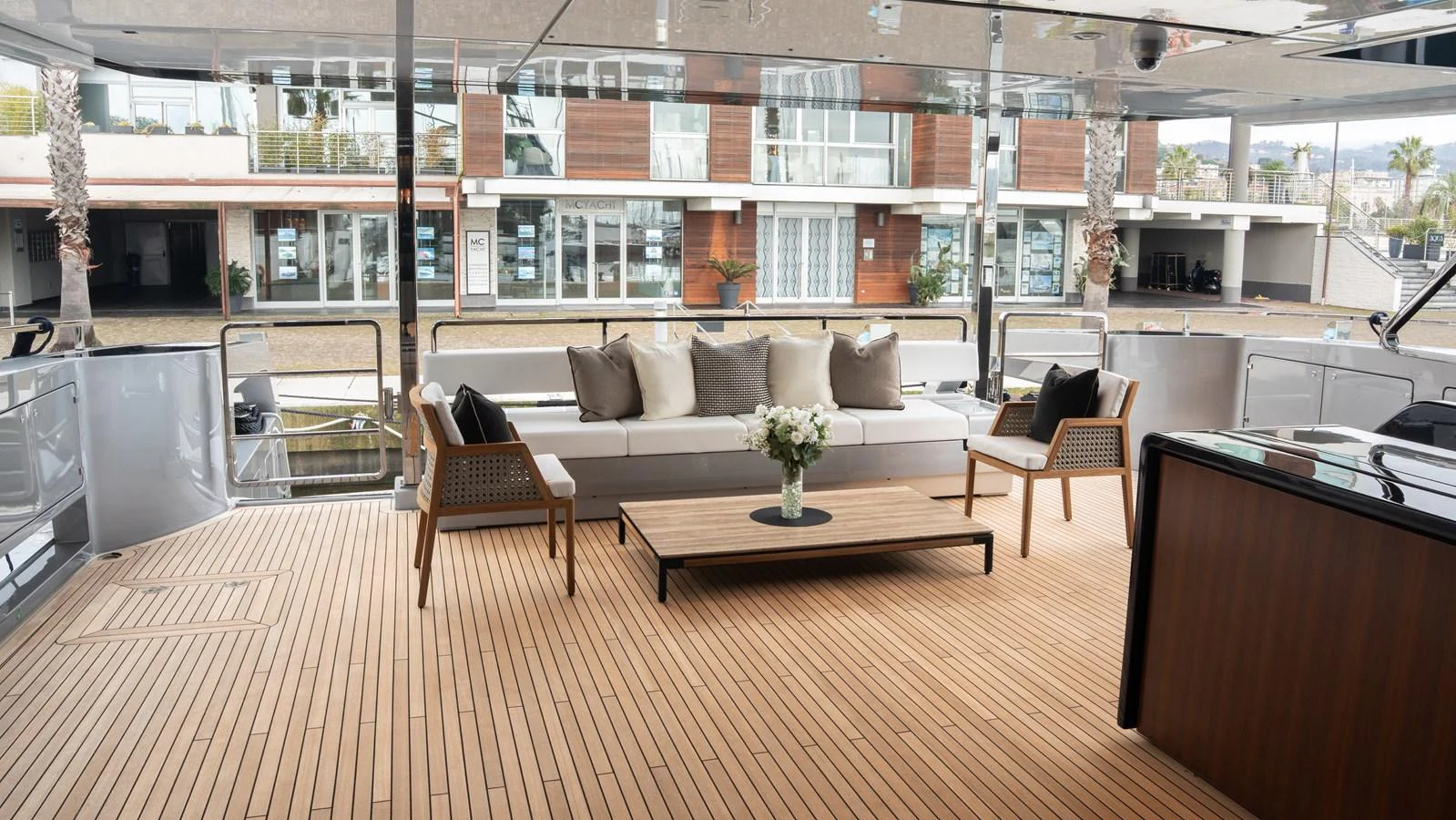 The aft deck features a stylish seating area with a comfortable sofa, chairs, and a coffee table, perfect for relaxation and socializing. aboard ´LANTE Yacht for Sale
