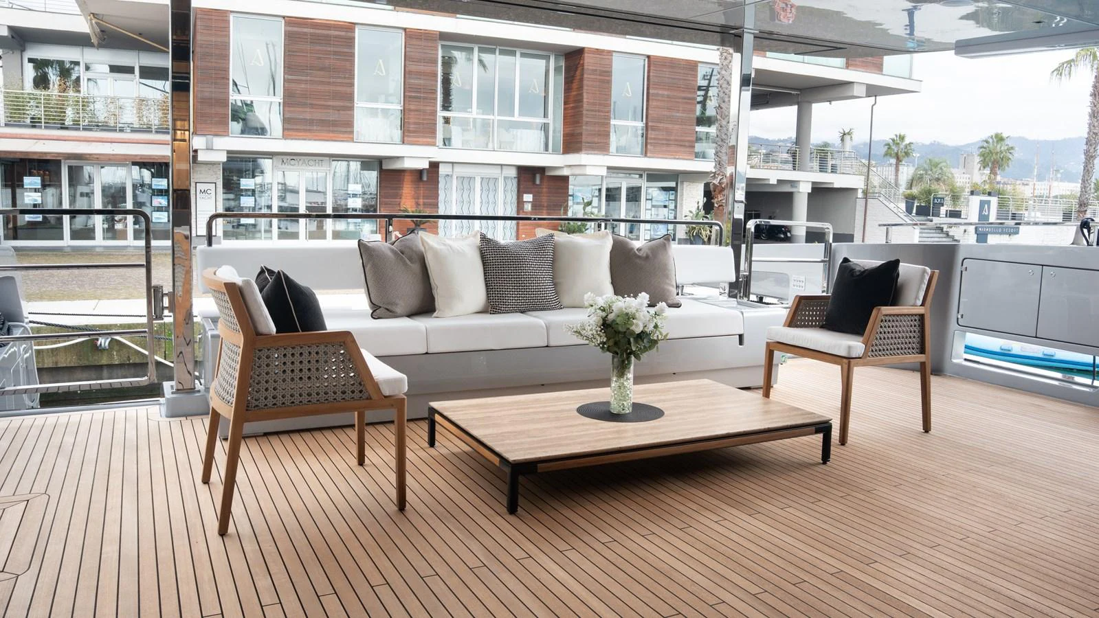 The aft deck features a stylish seating area with a modern sofa, chairs, and a coffee table, perfect for relaxation. aboard ´LANTE Yacht for Sale