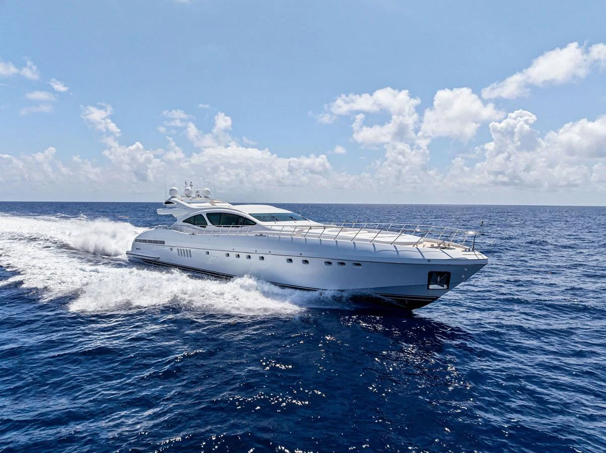A sleek and modern yacht cruises swiftly across the open sea under a clear blue sky. aboard INCOGNITO Yacht for Sale