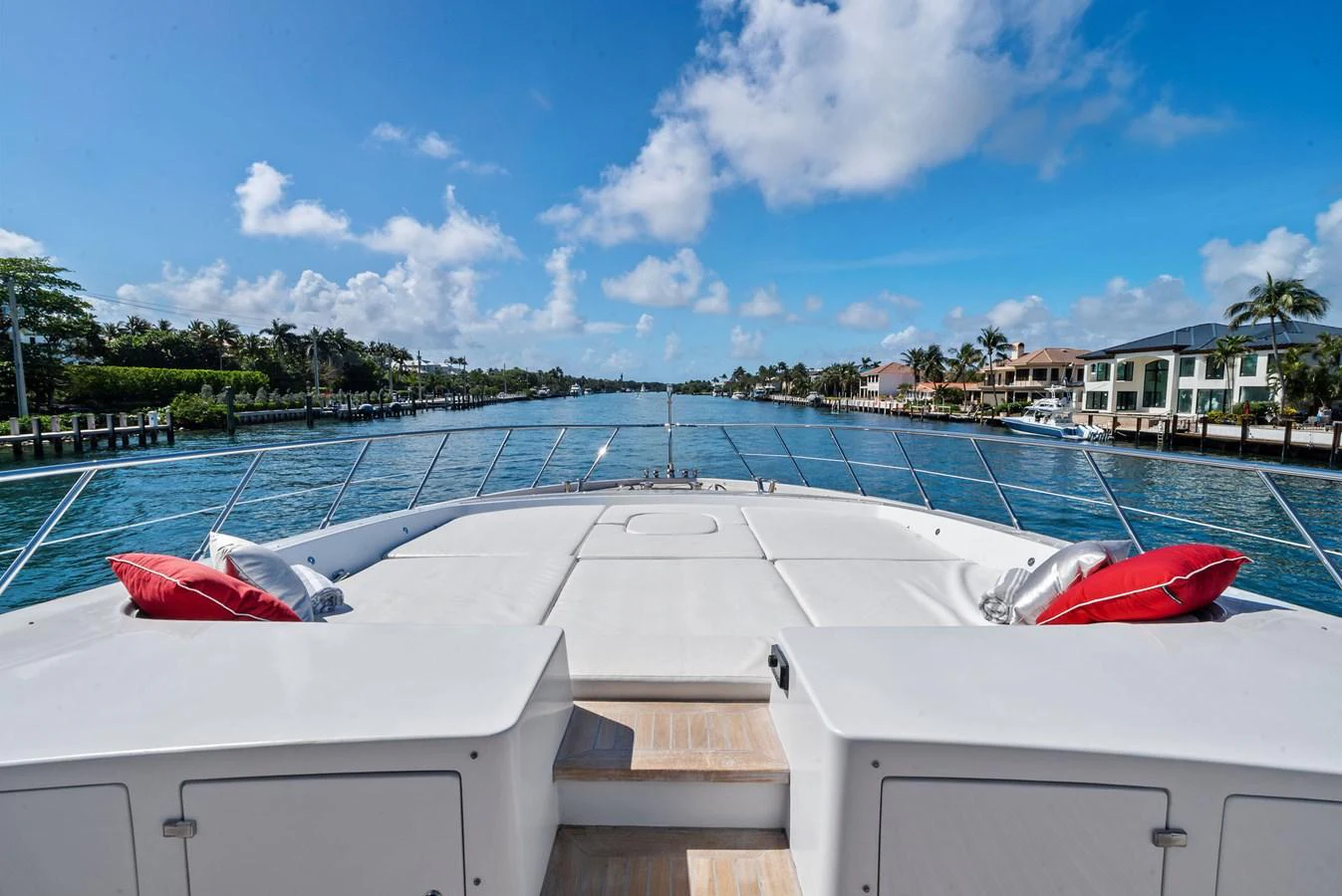 The foredeck offers a spacious sunbathing area with plush cushions and a stunning view of the waterway. aboard INCOGNITO Yacht for Sale