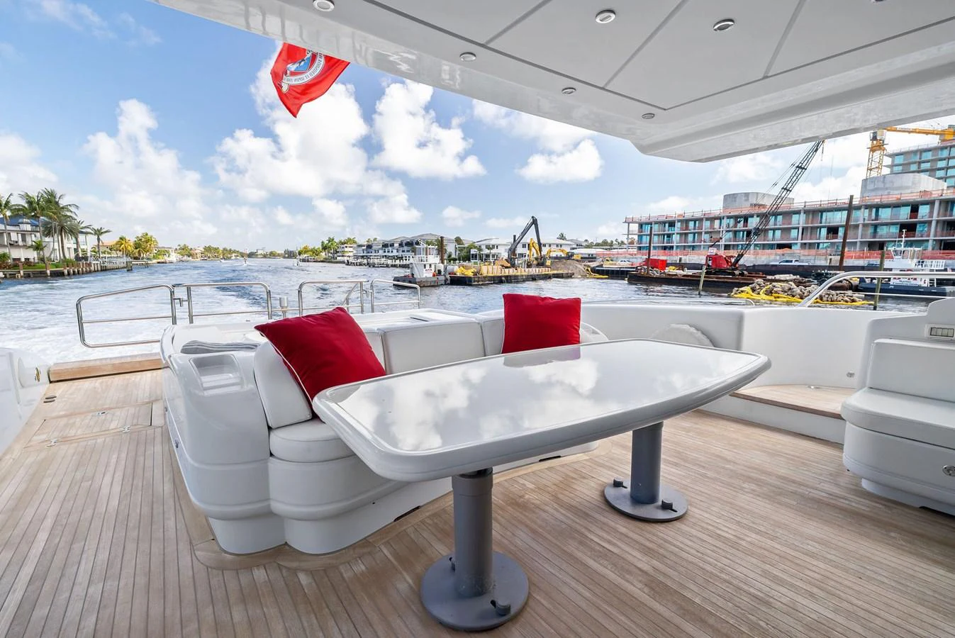 The aft deck features a sleek dining area with a modern table and comfortable seating, perfect for enjoying waterfront views. aboard INCOGNITO Yacht for Sale