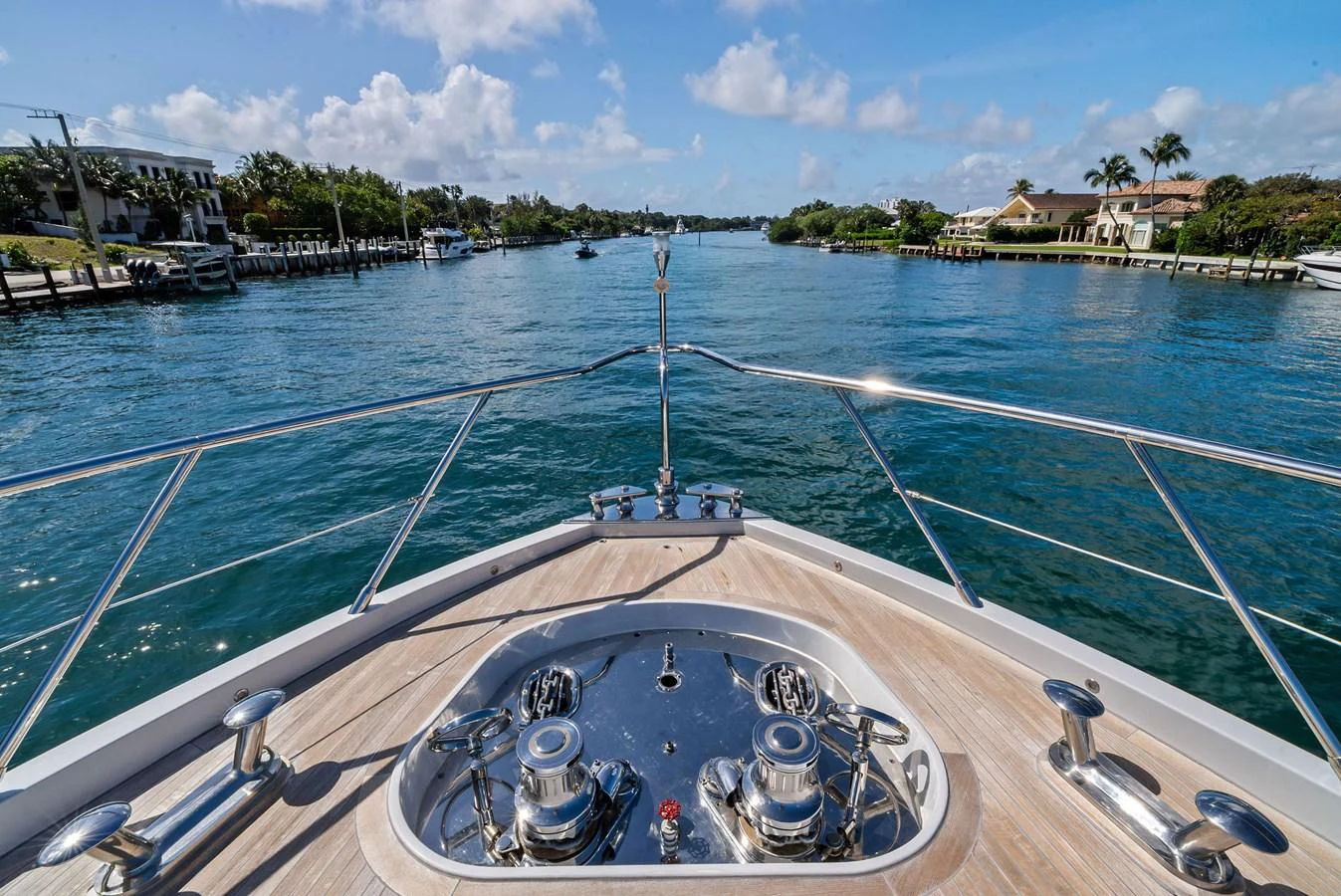 The yacht's bow features polished stainless steel fittings and a clear view of the waterway ahead. aboard INCOGNITO Yacht for Sale