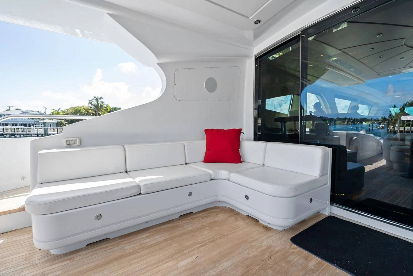 The aft deck features a comfortable white seating area with a vibrant red cushion, perfect for relaxation. aboard INCOGNITO Yacht for Sale