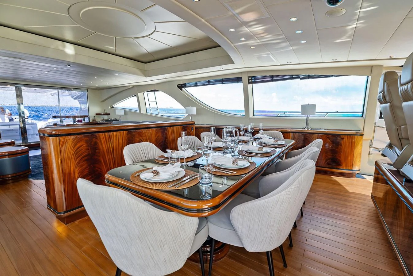 The yacht's dining area features elegant table settings and panoramic windows offering stunning sea views. aboard INCOGNITO Yacht for Sale