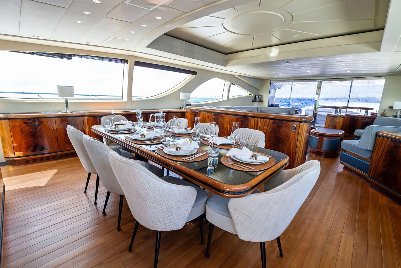 The yacht's dining area features elegant seating and a beautifully set table, perfect for luxurious meals with a view. aboard INCOGNITO Yacht for Sale