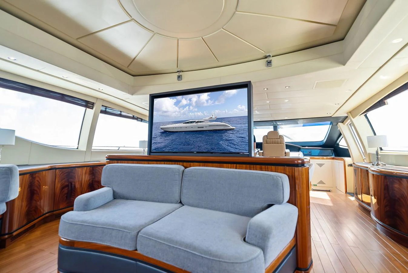 The spacious interior lounge features elegant wood finishes and a large flat-screen TV. aboard INCOGNITO Yacht for Sale