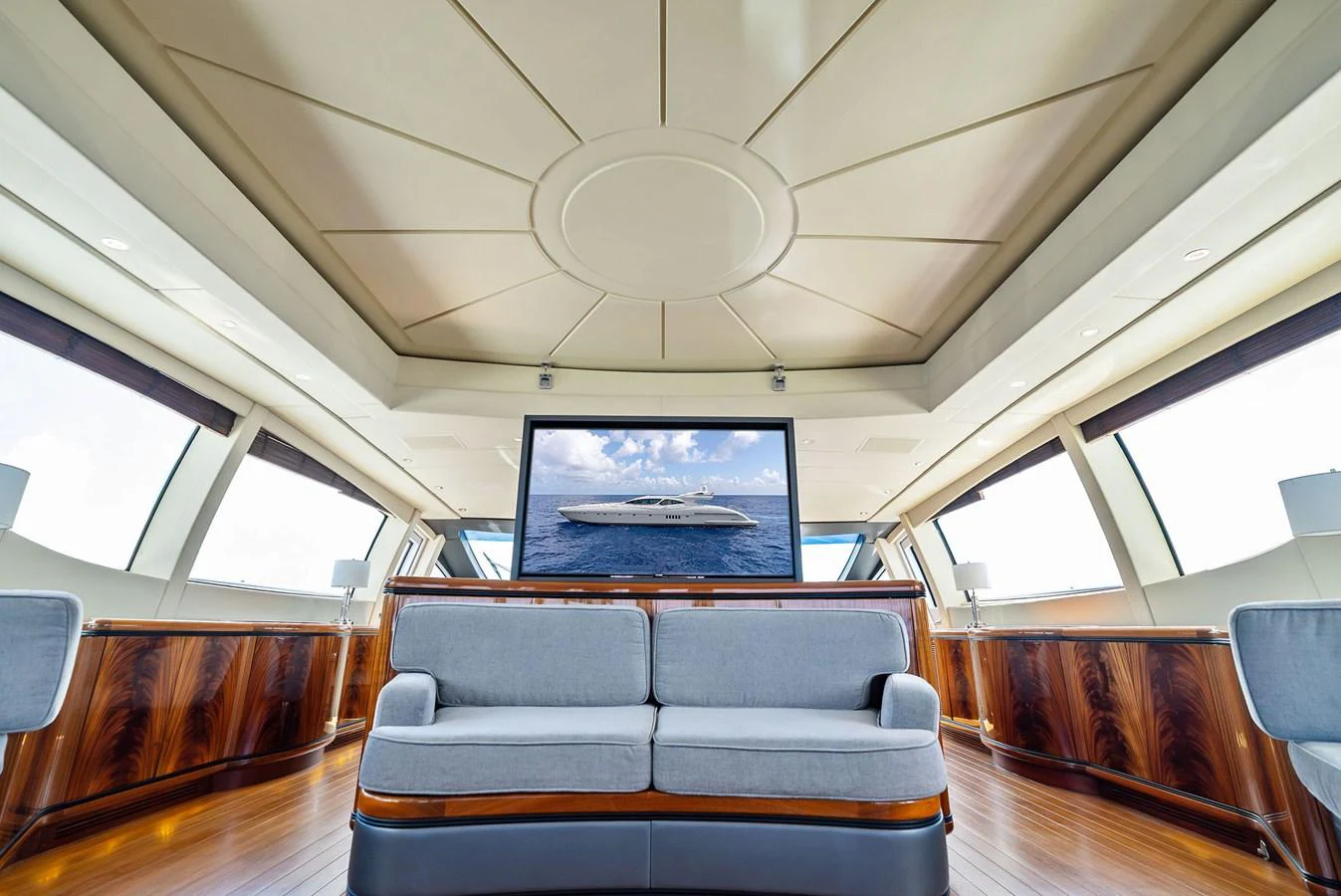 The salon features a luxurious seating area with a large television and panoramic windows. aboard INCOGNITO Yacht for Sale