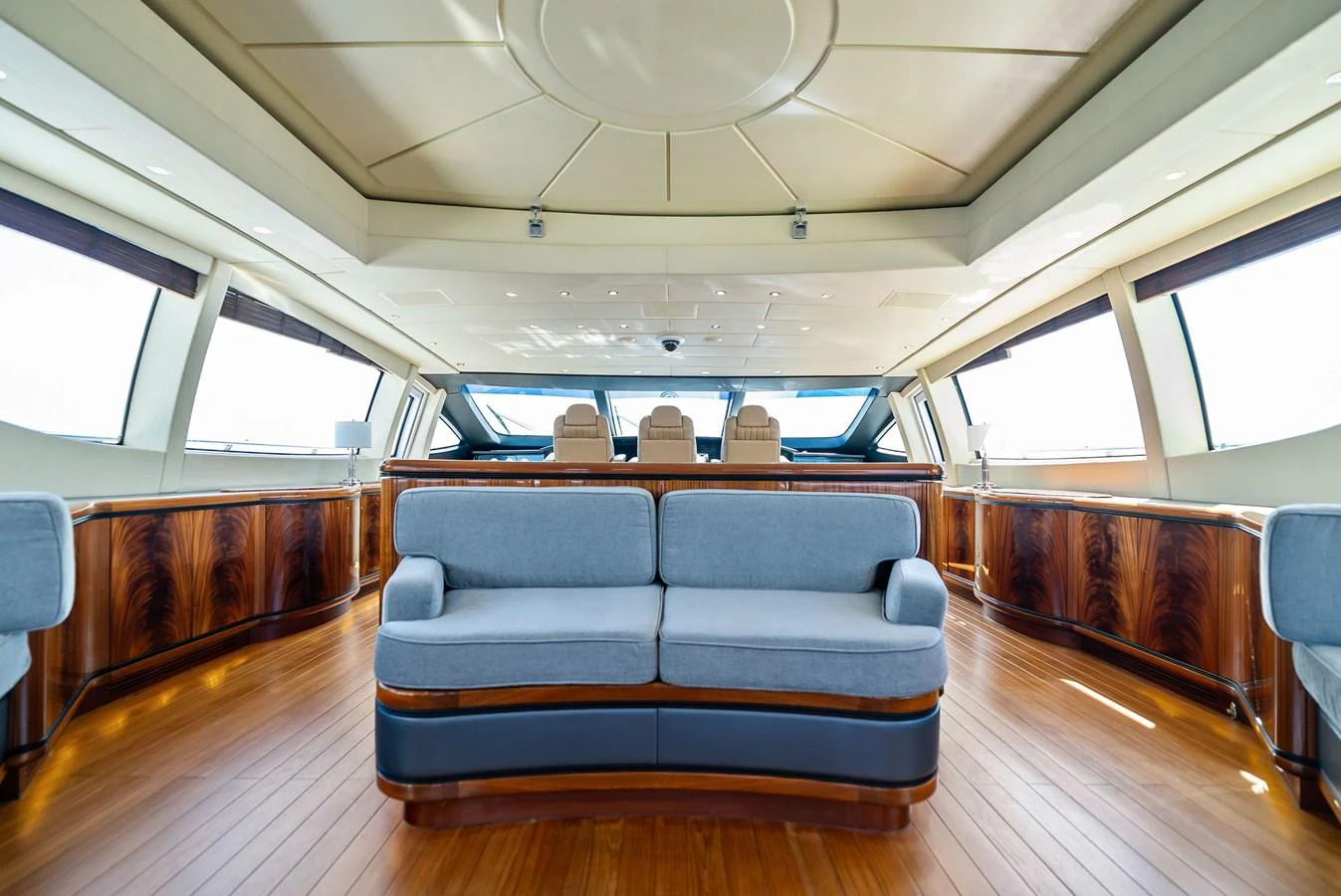 The salon features elegant wood flooring, plush seating, and panoramic windows for a luxurious experience. aboard INCOGNITO Yacht for Sale