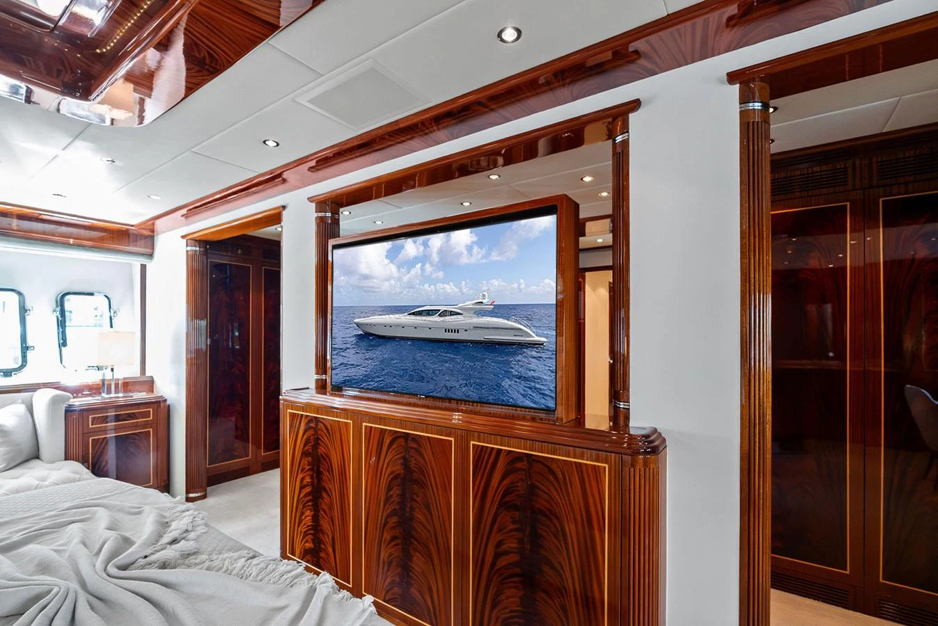 The stateroom features luxurious wood paneling and a large flat-screen TV for entertainment. aboard INCOGNITO Yacht for Sale