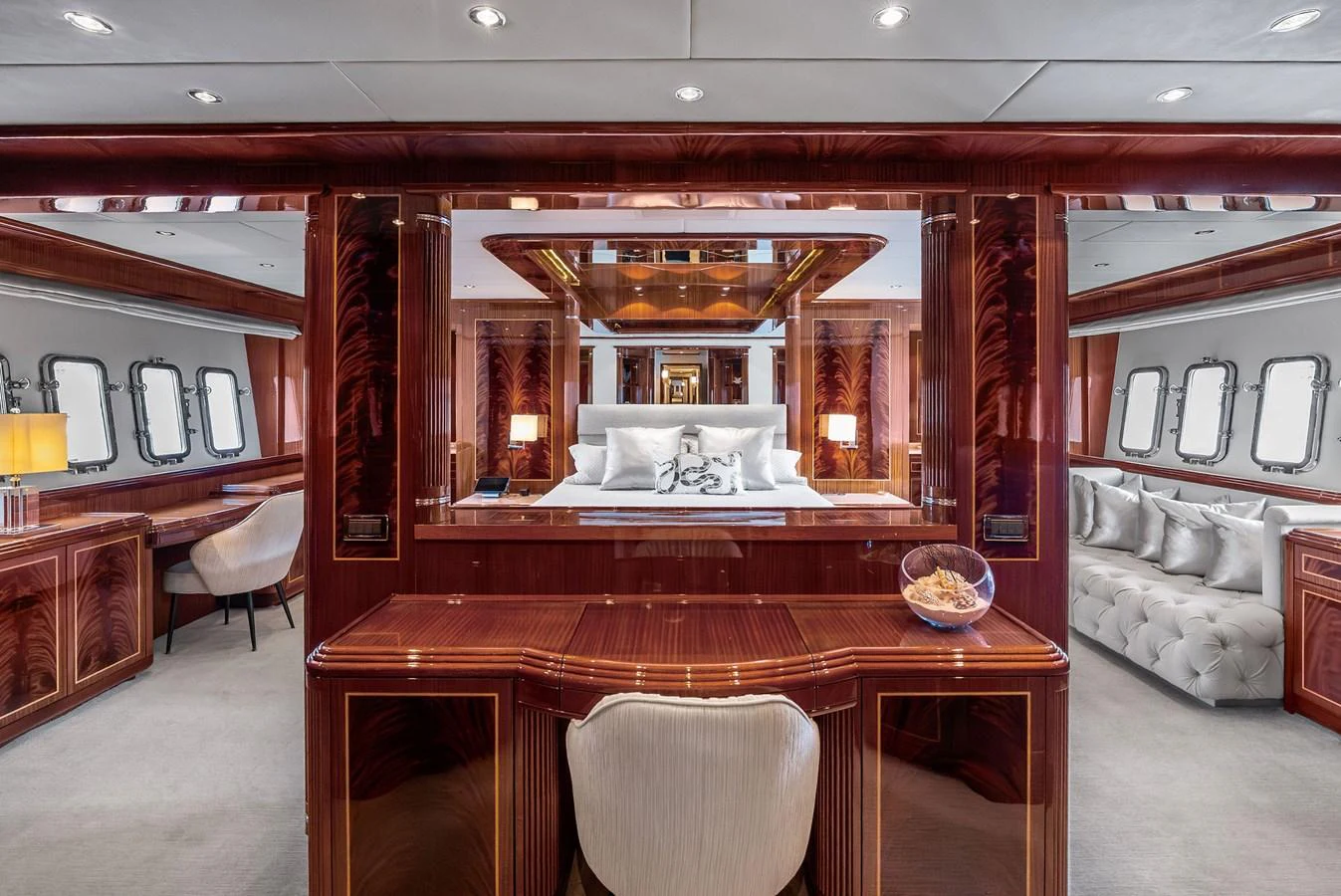The master stateroom features luxurious wood paneling, plush bedding, and elegant furnishings. aboard INCOGNITO Yacht for Sale