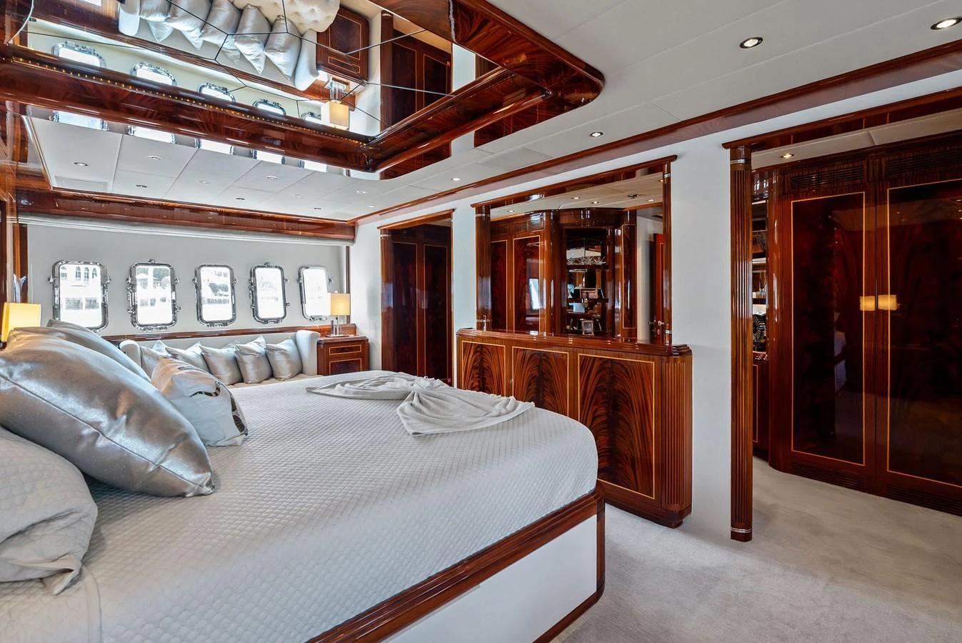 The master stateroom features luxurious bedding and elegant wood finishes, creating a serene and opulent retreat. aboard INCOGNITO Yacht for Sale