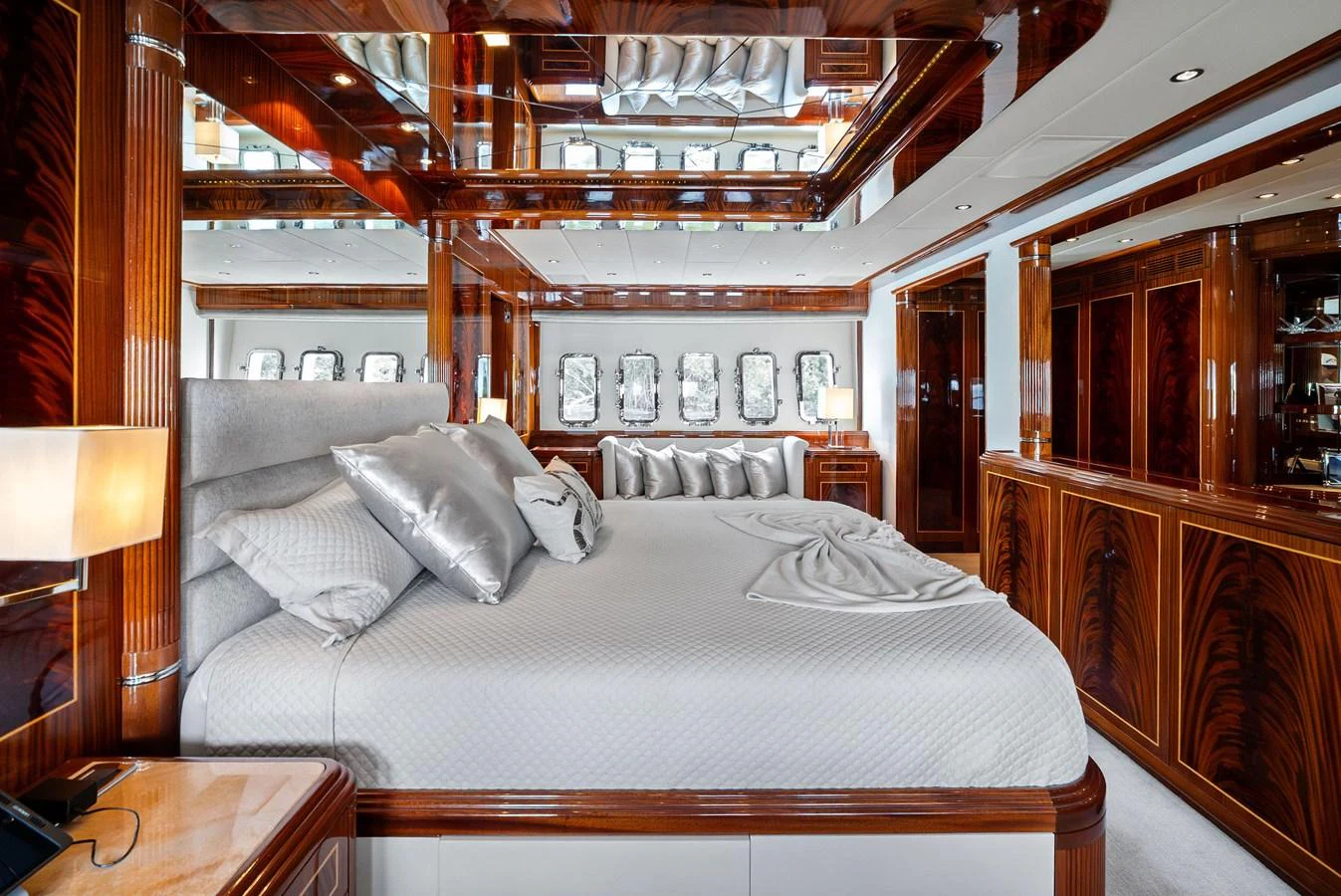 The master stateroom features luxurious bedding and elegant wood finishes, creating a serene and opulent retreat. aboard INCOGNITO Yacht for Sale