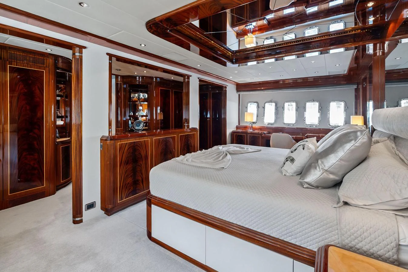 The master stateroom features luxurious wood finishes and a spacious, comfortable bed. aboard INCOGNITO Yacht for Sale