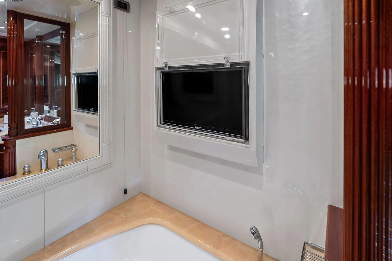 The yacht's interior features a luxurious bathroom with a built-in television above the bathtub. aboard INCOGNITO Yacht for Sale