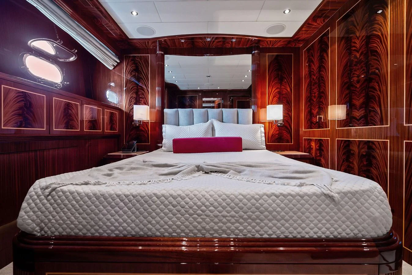 The stateroom features luxurious wood paneling and elegant bedding, creating a warm and inviting atmosphere. aboard INCOGNITO Yacht for Sale