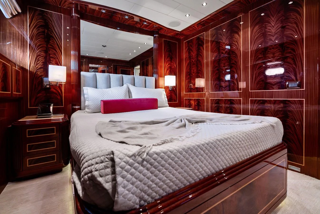 The master stateroom features luxurious wood paneling and a plush bed with elegant bedding. aboard INCOGNITO Yacht for Sale