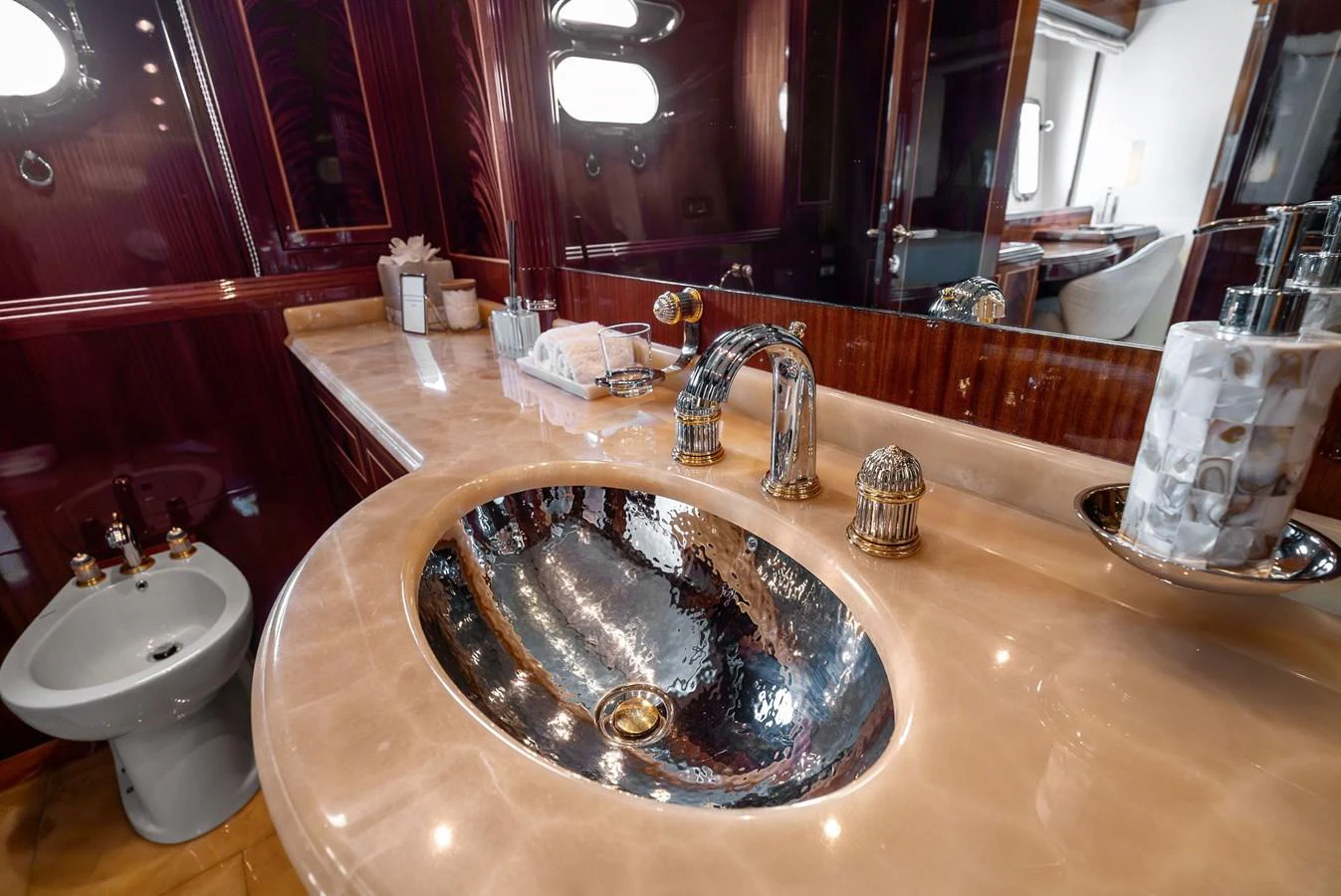 The yacht's bathroom features a luxurious sink with elegant fixtures and a polished countertop. aboard INCOGNITO Yacht for Sale